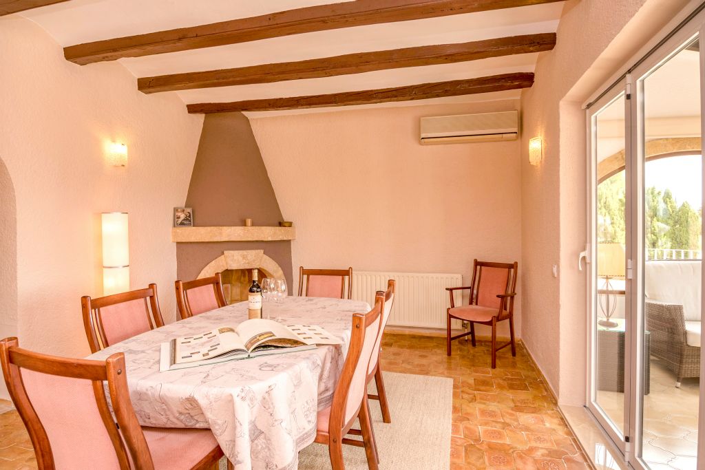 The extensible dining table is situated next to the kitchen and easy to access.